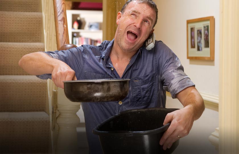 man calling plumber as ceiling is leaking